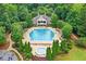 Aerial view of a community pool with a clubhouse and surrounding trees at 1065 Bookhout Drive Dr, Cumming, GA 30041