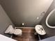 Charming half bathroom featuring a pedestal sink, mirror, and toilet at 5768 Windgate Ln, Lithonia, GA 30058