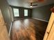 Bedroom featuring wood-look flooring, two windows, and a ceiling fan at 5768 Windgate Ln, Lithonia, GA 30058