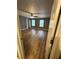 Spacious bedroom with new wood flooring, two windows, and a ceiling fan at 5768 Windgate Ln, Lithonia, GA 30058