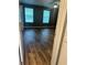 Bedroom featuring wood-look flooring, two windows, and a ceiling fan at 5768 Windgate Ln, Lithonia, GA 30058