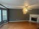 Inviting living room featuring hardwood floors, neutral paint, fireplace, ceiling fan and bright window at 5768 Windgate Ln, Lithonia, GA 30058