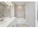 Beautiful bathroom featuring a double sink vanity, large mirror and tiled shower with a tub at 621 Hanlon Way, Alpharetta, GA 30009