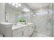 A luxurious main bathroom features double sinks, quartz countertops, a glass shower, and marble accents at 621 Hanlon Way, Alpharetta, GA 30009