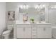 A main bathroom has double sinks, a large mirror, quartz countertops, and modern fixtures at 621 Hanlon Way, Alpharetta, GA 30009