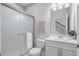 Modern bathroom features a glass-enclosed shower, toilet, and a vanity with a white countertop and sink at 621 Hanlon Way, Alpharetta, GA 30009