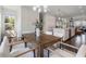 Dining room with a wooden table and modern chairs, leading to the kitchen and living area at 621 Hanlon Way, Alpharetta, GA 30009
