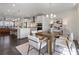 Open concept living space with a dining area with views of the kitchen and living room at 621 Hanlon Way, Alpharetta, GA 30009