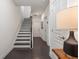 Bright hallway features stairs with dark treads, white risers, and wood floors leading to other rooms at 621 Hanlon Way, Alpharetta, GA 30009
