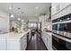 Well-lit kitchen offering stainless steel appliances and seamless integration with adjacent living spaces at 621 Hanlon Way, Alpharetta, GA 30009