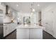 Modern kitchen features a large island, white cabinets, and stainless steel appliances at 621 Hanlon Way, Alpharetta, GA 30009
