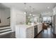 Bright kitchen showcasing a large center island, stainless steel appliances, and dark wood flooring at 621 Hanlon Way, Alpharetta, GA 30009