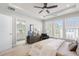 A main bedroom featuring large windows, a ceiling fan, an ensuite bathroom, and a sitting area at 621 Hanlon Way, Alpharetta, GA 30009
