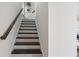 Staircase featuring dark wood stairs and railing contrasted with bright white walls, creating a modern look at 621 Hanlon Way, Alpharetta, GA 30009