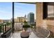 City view from balcony with stylish seating, planters, and brick accents at 75 Ponce De Leon Ne Ave # 1006, Atlanta, GA 30308