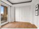 Bedroom with wood floors, balcony view and built-in wardrobe with stylish hardware at 75 Ponce De Leon Ne Ave # 1006, Atlanta, GA 30308