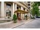 Exterior of building featuring a covered entrance, decorative architecture, and mature trees at 75 Ponce De Leon Ne Ave # 1006, Atlanta, GA 30308