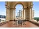Elegant covered terrace with beautiful city views, architectural columns and wrought iron furniture for lounging and entertaining at 75 Ponce De Leon Ne Ave # 1006, Atlanta, GA 30308