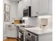 Galley kitchen with modern appliances, white cabinetry, and marble countertops for a sleek and efficient cooking space at 75 Ponce De Leon Ne Ave # 1006, Atlanta, GA 30308