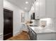 Galley kitchen featuring white cabinets, modern appliances, marble countertops, and hardwood floors at 75 Ponce De Leon Ne Ave # 1006, Atlanta, GA 30308