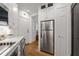 Galley kitchen featuring stainless steel appliances, white cabinets, marble countertops, and hardwood floors at 75 Ponce De Leon Ne Ave # 1006, Atlanta, GA 30308