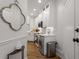Galley kitchen showcasing white cabinets, modern appliances, marble countertops, and hardwood floors at 75 Ponce De Leon Ne Ave # 1006, Atlanta, GA 30308