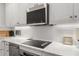 Kitchen features white subway tile backsplash, modern appliances, under cabinet lighting and marble countertops at 75 Ponce De Leon Ne Ave # 1006, Atlanta, GA 30308