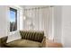 Bright living area features city views from the large windows and a decorative floor lamp at 75 Ponce De Leon Ne Ave # 1006, Atlanta, GA 30308