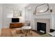 Bright living room featuring a fireplace, wood floors, and detailed molding throughout at 75 Ponce De Leon Ne Ave # 1006, Atlanta, GA 30308