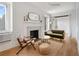 Bright living room featuring a decorative fireplace, comfortable seating, and hardwood floors at 75 Ponce De Leon Ne Ave # 1006, Atlanta, GA 30308