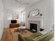 Bright living room featuring a fireplace, wood floors, and detailed molding throughout at 75 Ponce De Leon Ne Ave # 1006, Atlanta, GA 30308
