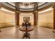 Elegant lobby with a large round table, columns, high ceilings, and decorative details at 75 Ponce De Leon Ne Ave # 1006, Atlanta, GA 30308