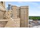 High-rise rooftop view of a high-rise apartment building and trees at 75 Ponce De Leon Ne Ave # 1006, Atlanta, GA 30308