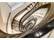 View looking down an ornate spiral staircase with decorative railings and tiled landings at 75 Ponce De Leon Ne Ave # 1006, Atlanta, GA 30308