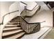 Elegant staircase with decorative railings and tiled flooring in a bright hallway at 75 Ponce De Leon Ne Ave # 1006, Atlanta, GA 30308