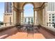Charming outdoor sitting area on the tiled terrace provides a relaxing space with views through the architectural details at 75 Ponce De Leon Ne Ave # 1006, Atlanta, GA 30308