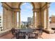 Beautiful city views from a covered outdoor terrace with wrought iron table and chairs and architectural details at 75 Ponce De Leon Ne Ave # 1006, Atlanta, GA 30308
