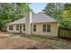 Exterior view of the back of the home with a large backyard and trees at 288 Old Burnt Hickory Rd, Acworth, GA 30101