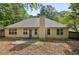 Back exterior view of the house with patio and green landscape at 288 Old Burnt Hickory Rd, Acworth, GA 30101