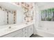 Bathroom with double sinks, floral wallpaper, soaking tub, and natural light at 288 Old Burnt Hickory Rd, Acworth, GA 30101