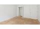 An empty bedroom with a view of the closet and doorway, bright walls, and unfinished flooring at 288 Old Burnt Hickory Rd, Acworth, GA 30101