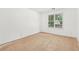 A light-filled bedroom with a large window, bright walls, and unfinished floors at 288 Old Burnt Hickory Rd, Acworth, GA 30101
