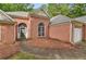 Charming brick home with arched entry and well-maintained landscaping at 288 Old Burnt Hickory Rd, Acworth, GA 30101
