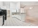 Kitchen with white cabinets, countertops, and flooring, flowing into an adjacent room at 288 Old Burnt Hickory Rd, Acworth, GA 30101
