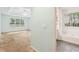 View of bedroom with tray ceiling and a bathroom with a large tub and window at 288 Old Burnt Hickory Rd, Acworth, GA 30101