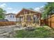 Backyard features a screened-in porch, a stone fire pit, and a newly built fence creating a cozy outdoor retreat at 1633 Woodbine Ne Ave, Atlanta, GA 30317