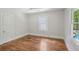 A bright bedroom with hardwood flooring, a ceiling fan, and ample natural light from the window at 1633 Woodbine Ne Ave, Atlanta, GA 30317