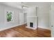 Cozy bedroom with a painted fireplace, ceiling fan, and natural light from the window at 1633 Woodbine Ne Ave, Atlanta, GA 30317