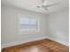 Minimalist bedroom with hardwood flooring, a ceiling fan, and natural light from the windows at 1633 Woodbine Ne Ave, Atlanta, GA 30317