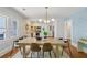 Stylish dining room with modern lighting, wallpaper accent, and a view into the updated kitchen at 1633 Woodbine Ne Ave, Atlanta, GA 30317